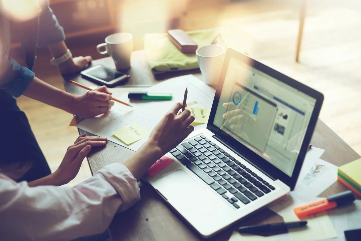 A considered financial advisory setting with documents and an office desk